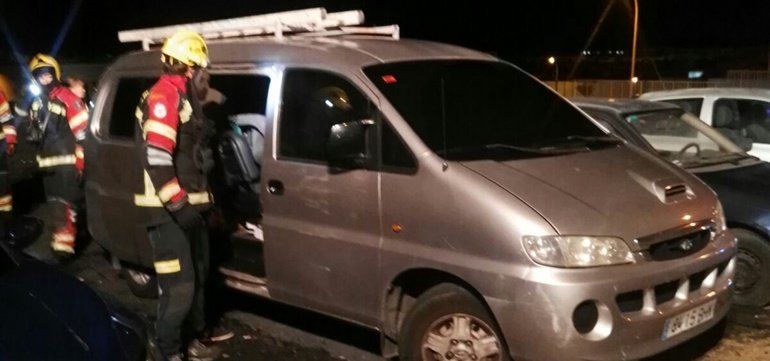 Firefighters extinguish a fire inside a van in Arrecife