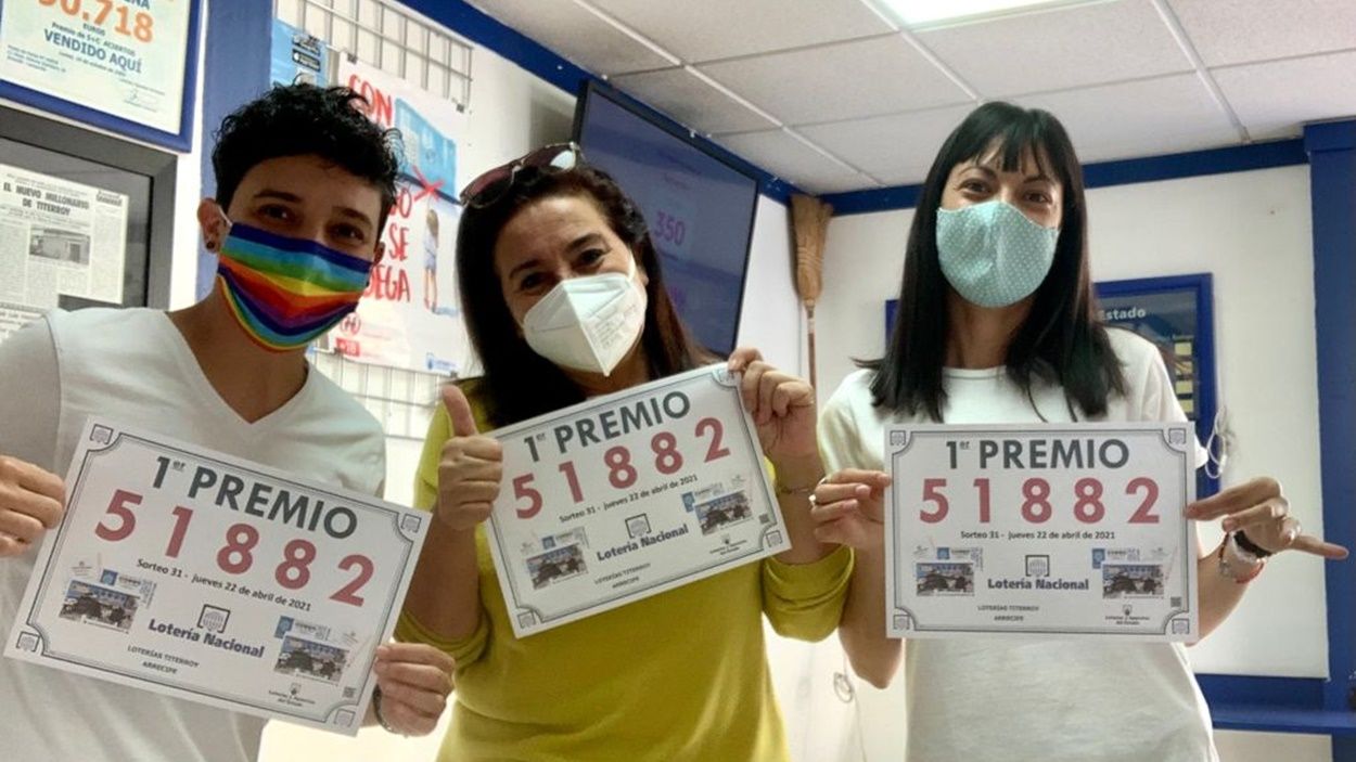 Lottery administration workers from Titerroy with the winning number sign