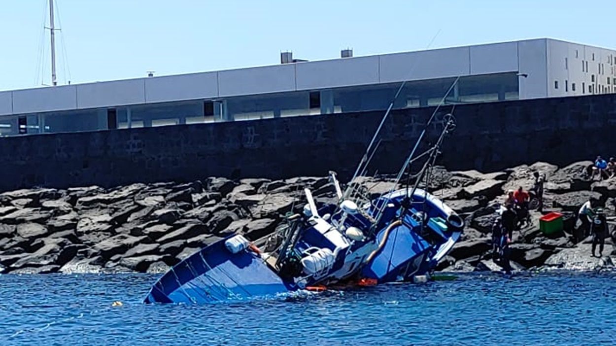Labores de rescate del barco pesquero encallado en el puerto deportivo de Arrecife