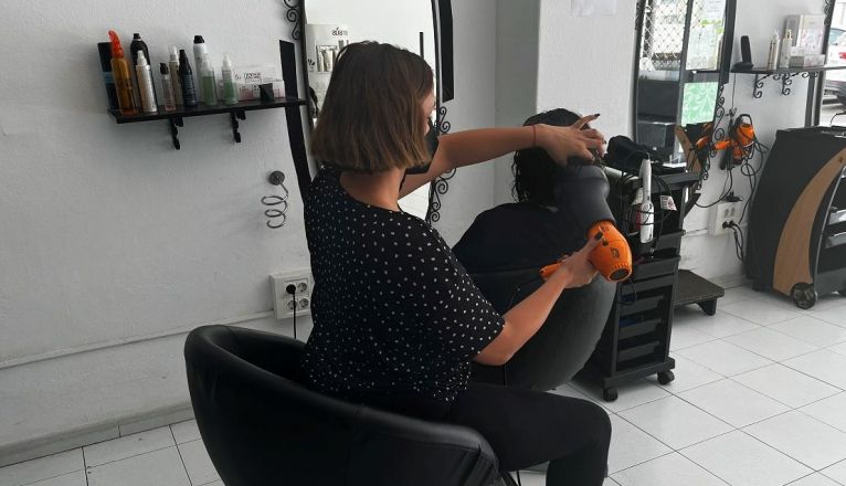 Una peluquera con mascarilla en Arrecife Una peluquera con mascarilla en Arrecife