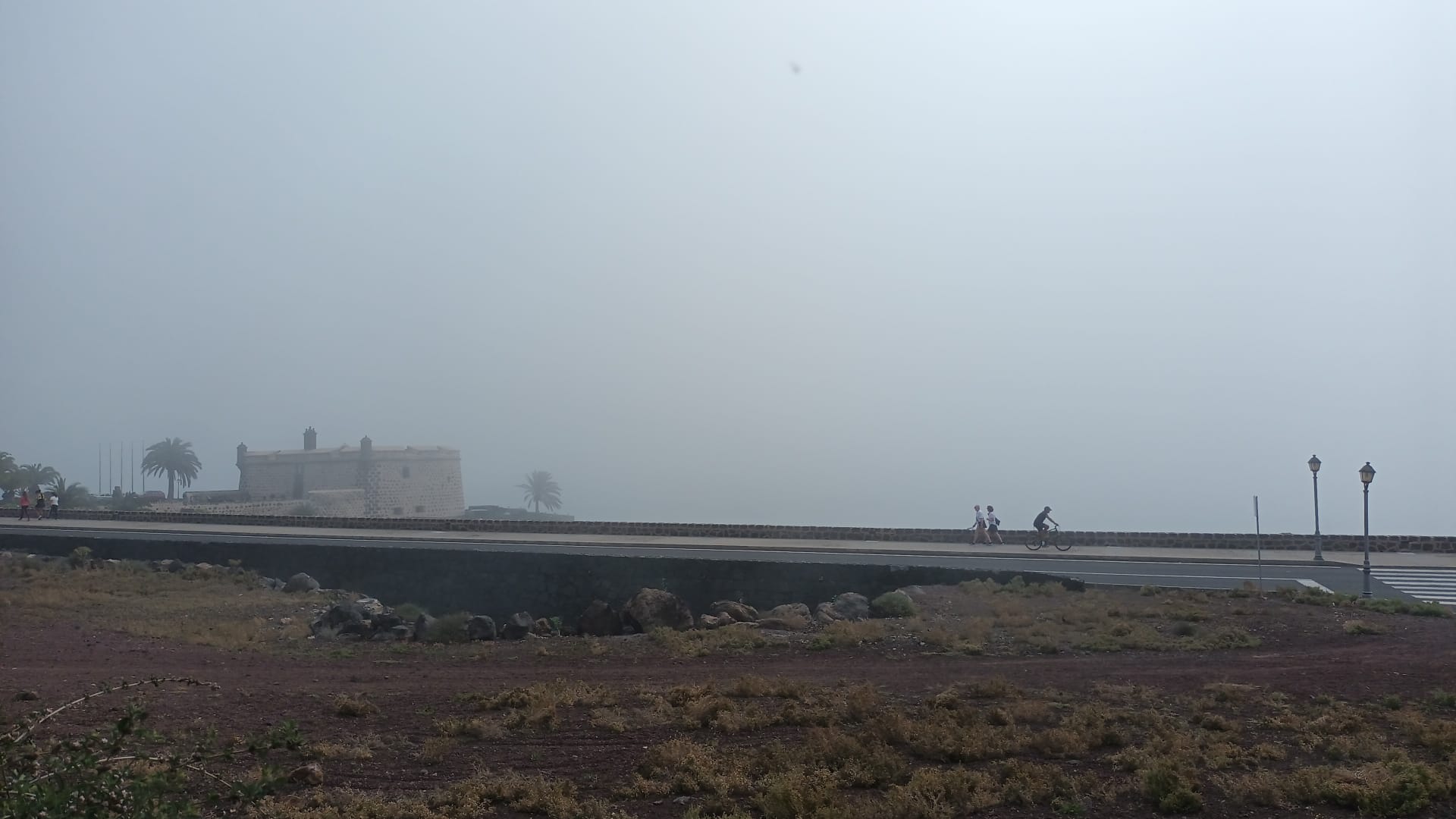 Avenida Naos y el castillo de San José cubiertos por la bruma