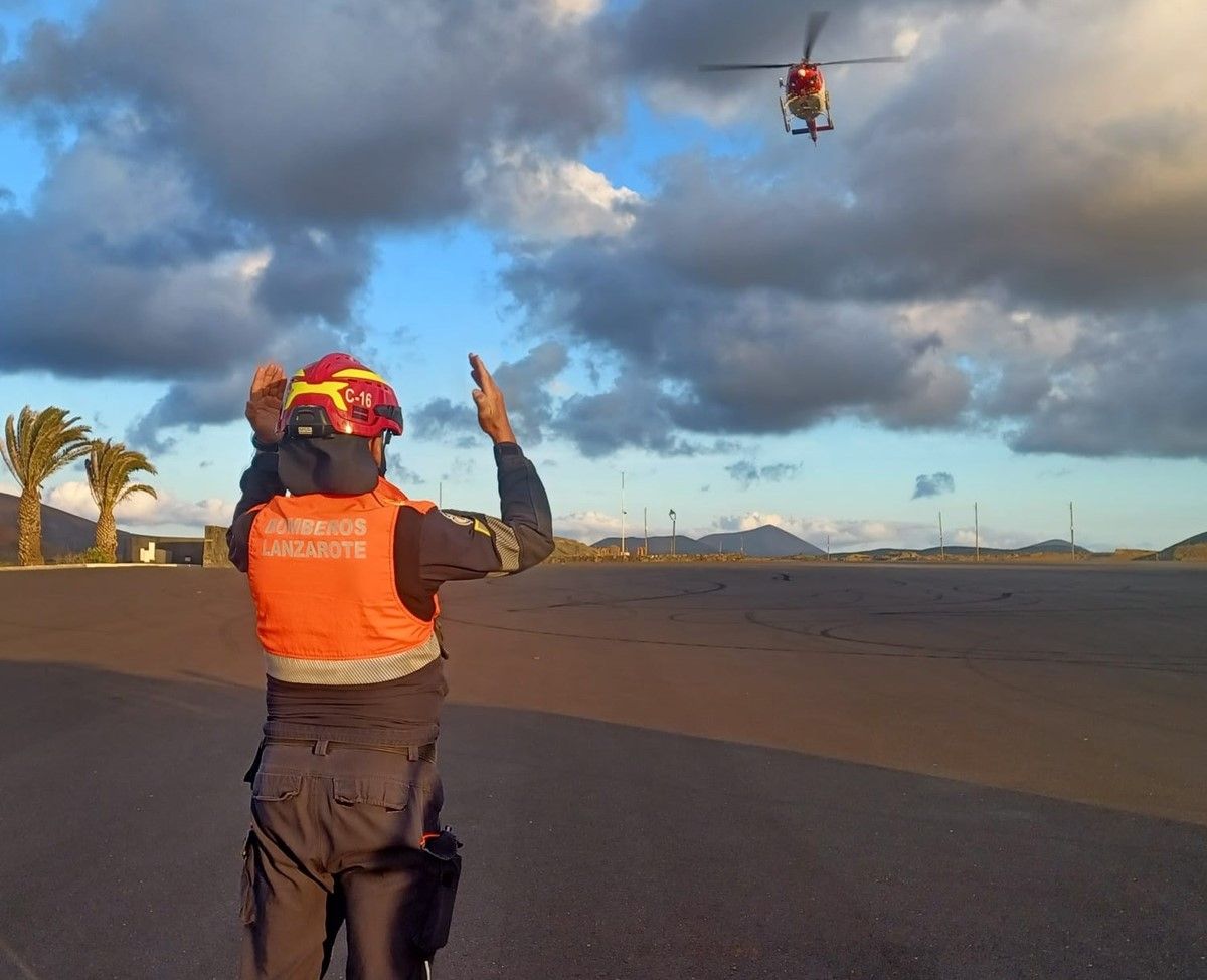 One of the firefighters and the helicopter during the hikers' rescue