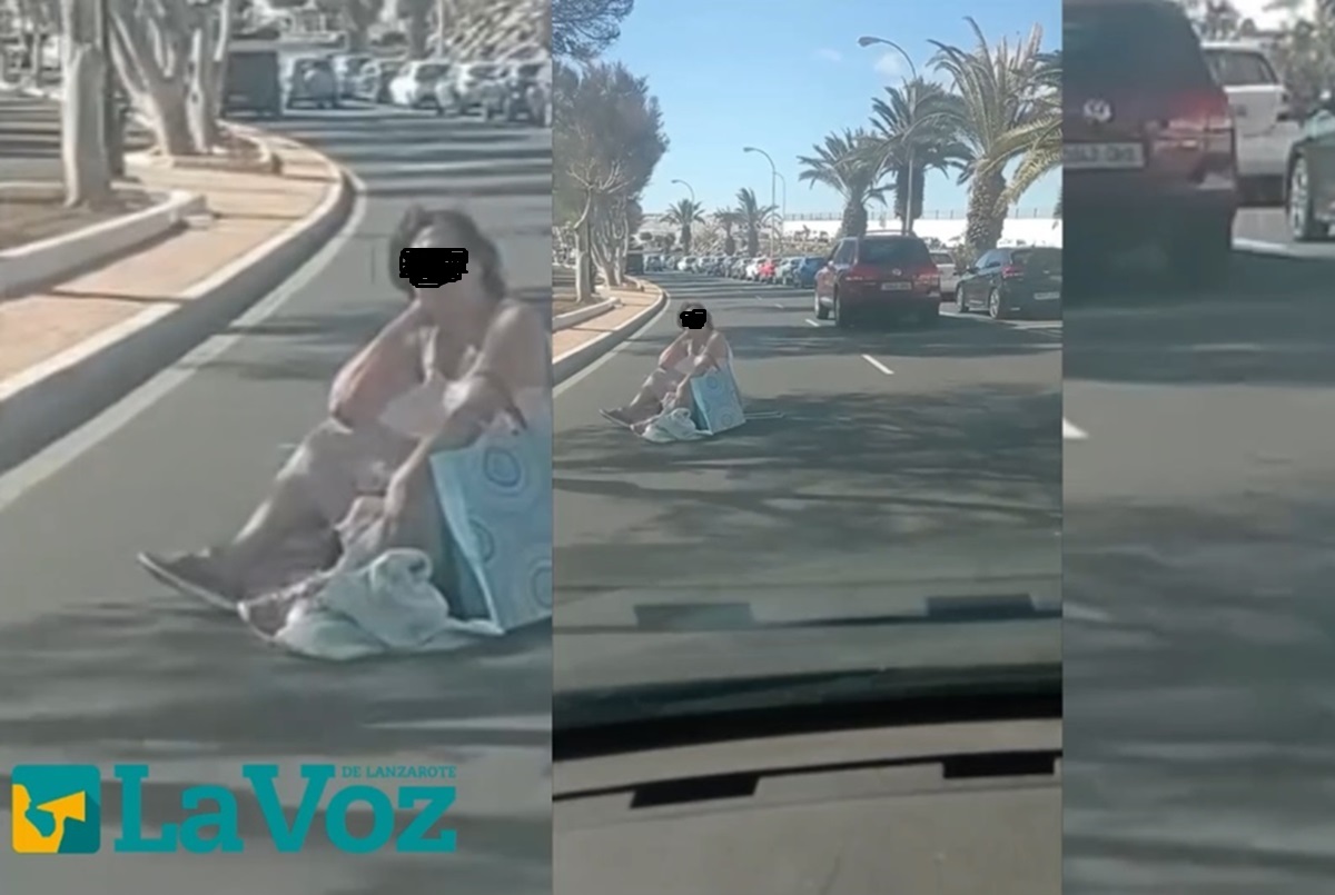 Imagen de la mujer sentada en la carretera de la Vía Medular