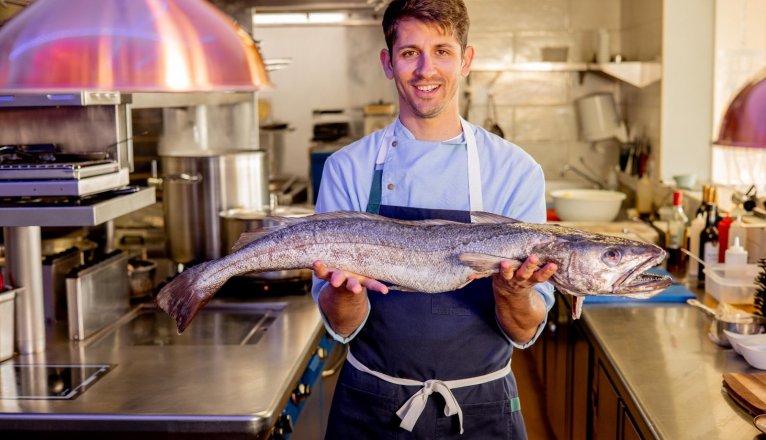 Perdomo poses with the fish of the day. Perdomo poses with the fish of the day.