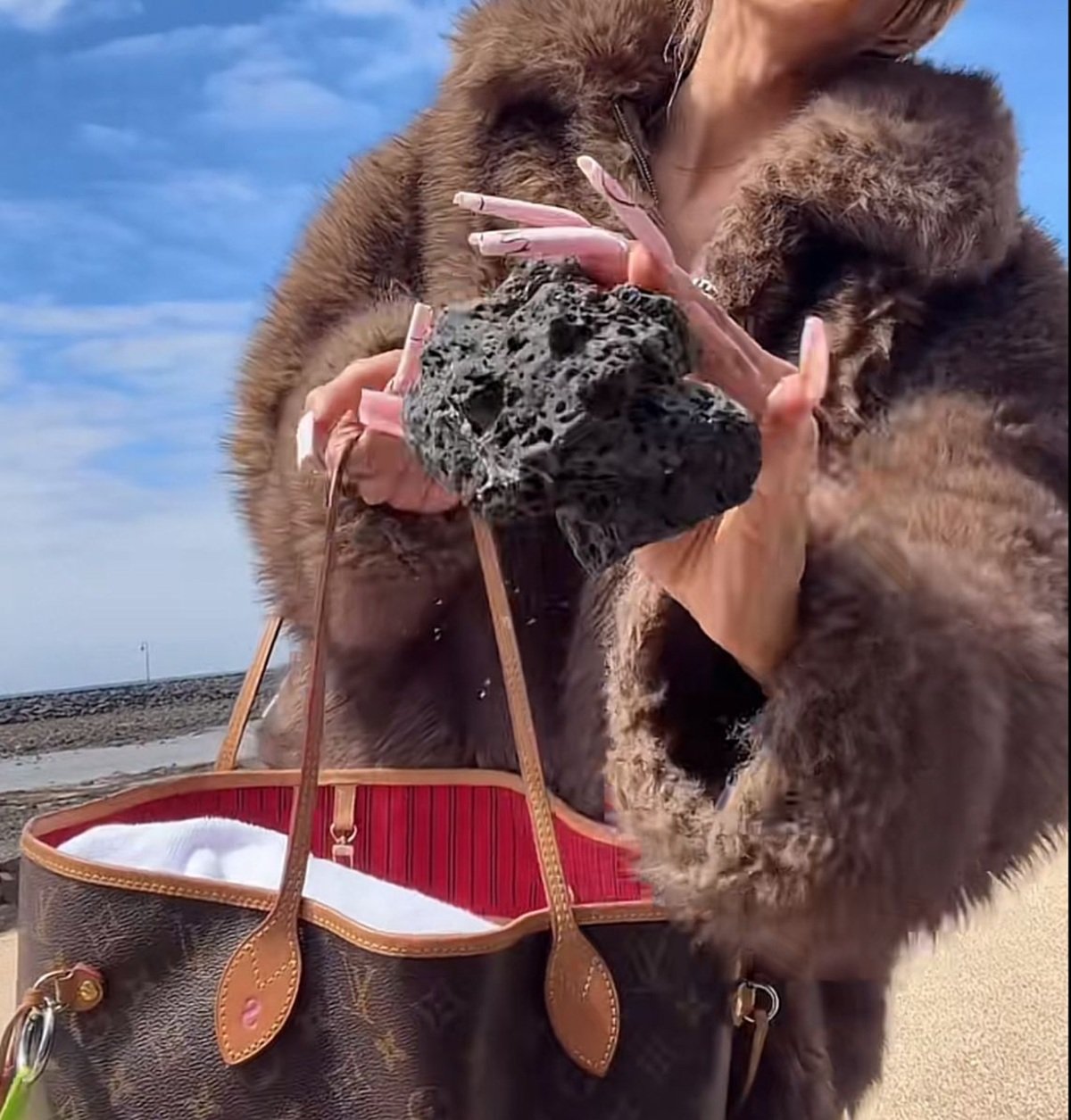 La creadora de contenido sacando la piedra del bolso