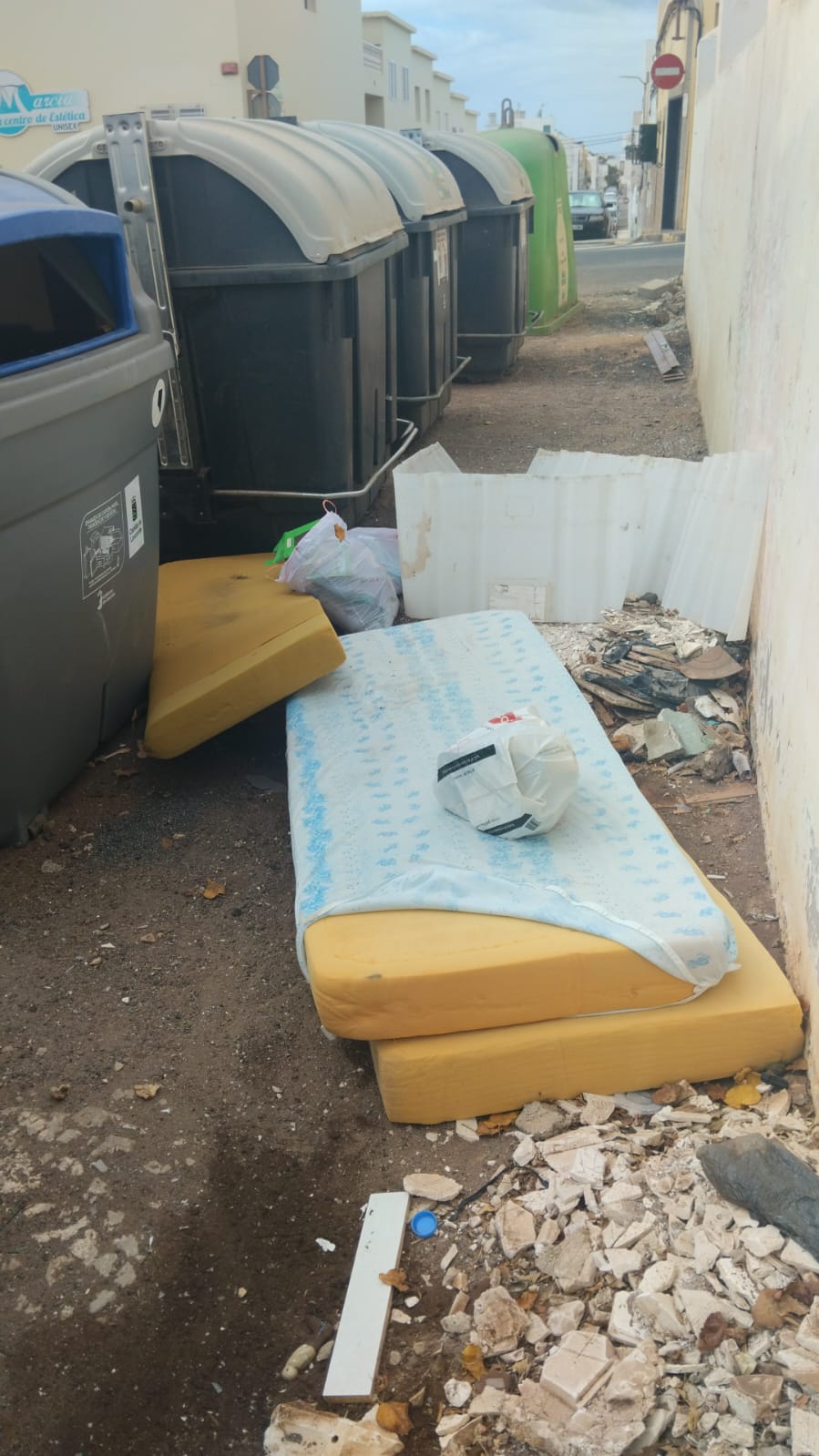 Varios enseres tirados por la gente junto a los contenedores en Arrecife