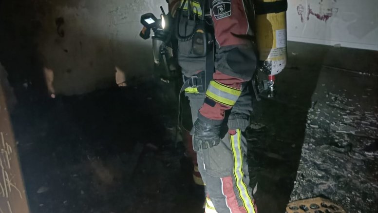 One of the firefighters checking the room affected by the fire in the La Santa shelter. Photo: Security Consortium.
