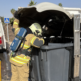 Bombero durante las tareas de extinción en el contenedor