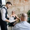 Un camarero atiende a dos clientes