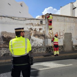Agentes de la Policía Local de Arrecife en la calle Blas Cabrera Topham para evitar el tránsito mientras los bomberos retiran los cascotes de la fachada de ese inmueble